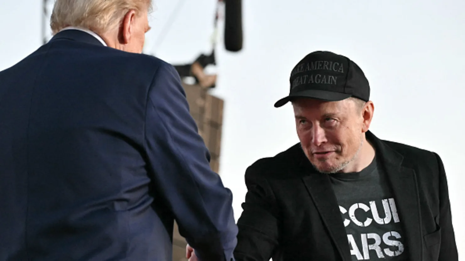 Tesla CEO Elon Musk (R) joins former U.S. President and Republican presidential candidate Donald Trump during a campaign rally at the site of his first assassination attempt in Butler