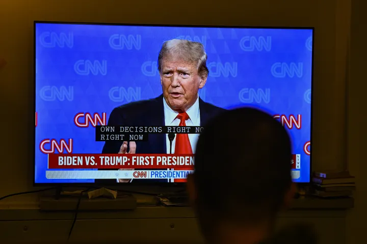 Donald Trump is displayed on a TV screen in Virginia on June 27, during his debate with President Joe Biden.