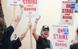 TOPSHOT - Union members react as Aerospace Machinists District 751 President Jon Holden (out of frame) announces that union members rejected a proposed Boeing contract and will go on strike, following voting results at their union hall in Seattle, Washington, on September 12, 2024. Boeing workers in the Seattle region overwhelmingly voted to strike on September 12, rejecting a contract the embattled aviation giant characterized as a boon for staff given the company's stressed financial condition. (Photo by Jason Redmond / AFP) (Photo by JASON REDMOND/AFP via Getty Images)