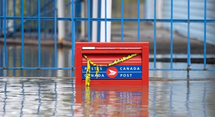 A partially flooded Canada Post mail box in the Gatineau, Que., region in May 2023. The company's revenue has been declining for the last six years and says its current financial challenges are "reaching a critical point."